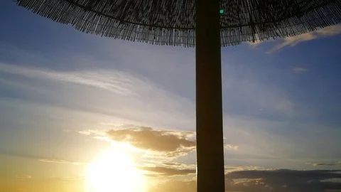 Under Umbrella Sunset tracking back-forth Stock Footage 97605668