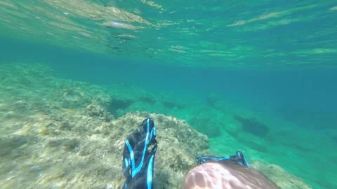 Under water personal view of man legs floating in clear transparent sea water Stock Footage 261798292