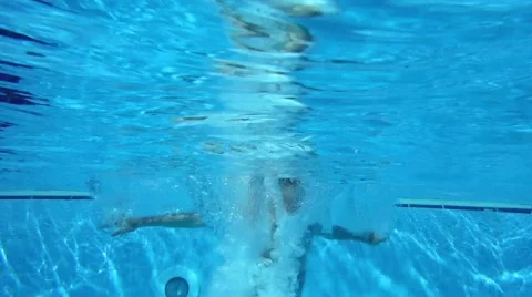 Under water shot of a man jumping in a pool Stock Footage 64064609