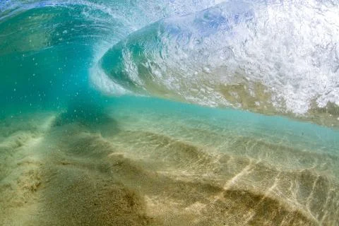 Under water wave breaking over sand in hawaii tropical island Stock Photos
