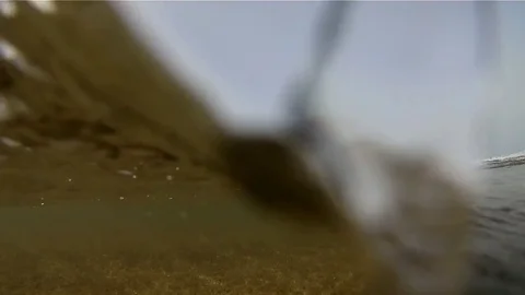 Under the waves of the water's edge beach Stock Footage 79605743