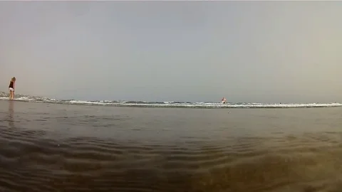 Under the waves of the water's edge Stock Footage 79605741