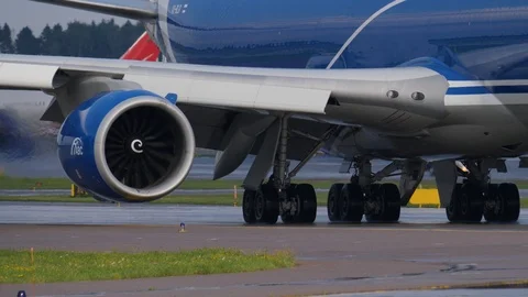Undercarriage and engine of Jambo Jet airplane moving on taxiway. Boeing 747 is Stockbeeldmateriaal 94514175