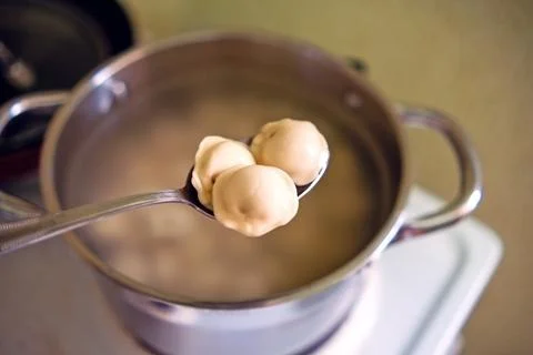 Undercooked dumplings on a spoon Stock Photos