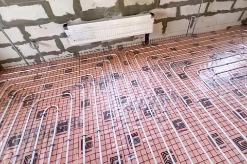 Underfloor heating system. Installation of underfloor heating. Stock Photos