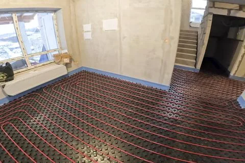 Underfloor heating system. Installation of underfloor heating. Stock Photos
