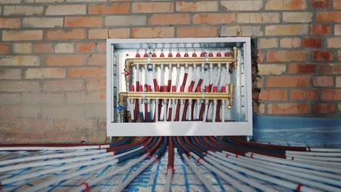 Underfloor heating system manifold and pipes installed on construction site.. Stock Footage 335059487