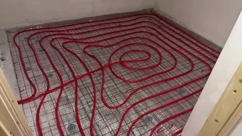 Underfloor heating water pipe layout on metal mesh Stock Footage 346718972