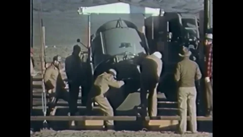 An underground atomic bomb is detonated amidst dummy buildings, during Operation Stock Footage 79514506