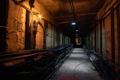 Underground cable tunnel with a cable coupling in the foreground. Underground Stock Photos