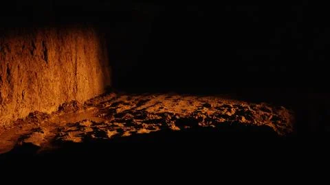 Underground cave illuminated by warm light creating contrast Stock Photos