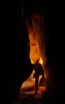 Underground cave passage with a caver Foto stock