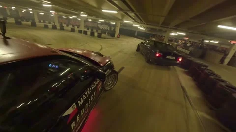 Underground Drift Battle Between Two BMWs in Tight Parking Garage Stock Footage 327027933