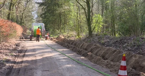 Underground fiber-optic cable laying in the Dutch countryside Stock Footage 105803120