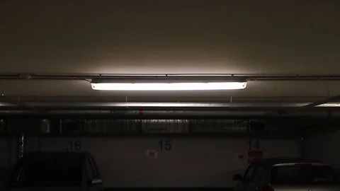 Underground garage with light beeing turned on Stock Footage 99321568