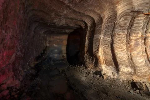Underground mine. Dead-end mining. The walls show the marks of the roadheader Stock Photos