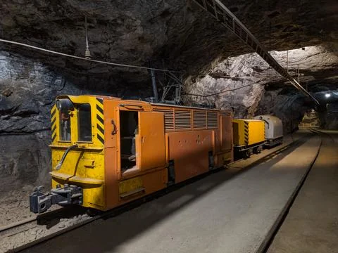 An underground mine railway system with old mining locomotive Stock Photos