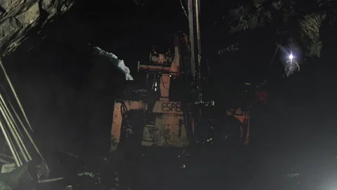 Underground Mining, Mine Worker looking at Rock Drilling Machine inside Mine. Stock Footage 165423704