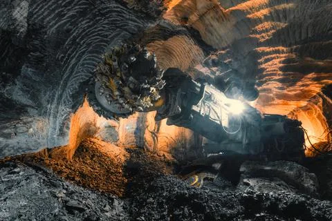 Underground mining of ore. Drilling head of a mine roadheader Stock Photos