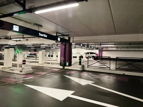 Underground parking exit with directional arrows and barriers in Paris, Fra.. Stock Photos