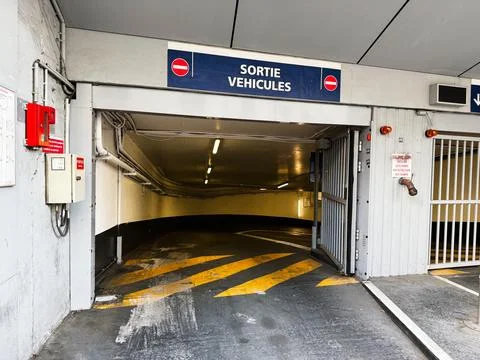 Underground parking exit ramp with yellow markings and Sortie Vehicules sig.. Stock Photos