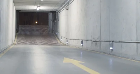 Underground parking space, industrial interior. electric gate is getting close. Stock Footage 127706194