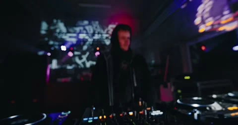 Underground Party DJ: Dancing and operating multiple elements on his Stock Footage 263708497