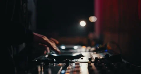 Underground Party DJ: Operating the touchscreen and twisting knobs on his 動画素材 263091878