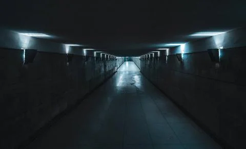 Underground passage with blue light Long and dark underground passage, poo... Stock Photos