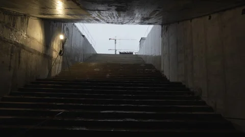 Underground passage opens toward bright city skyline Видео 310229612