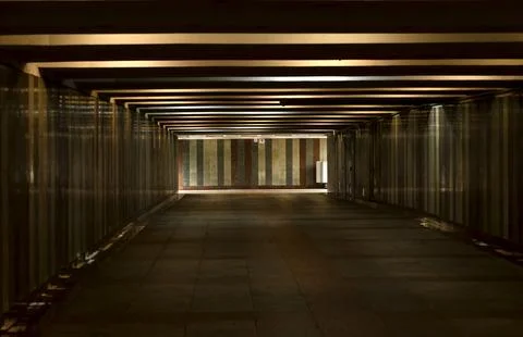Underground passage with perspective lines and light at the end. Long corrido Stock Photos
