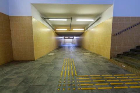 Underground passage to the train station platform. Infrastructure for traveli Stock Photos