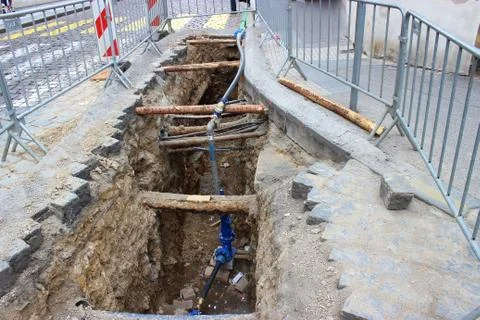 Underground pipe being fixed in trench Stock Photos