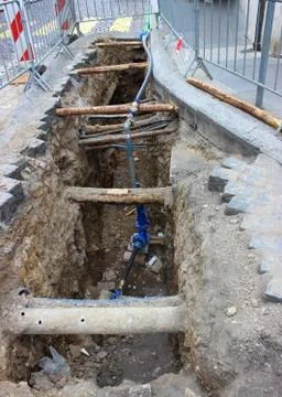 Underground pipe being fixed in trench Stock Photos