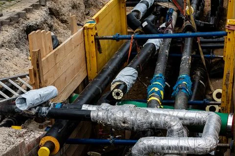 Underground piping network at construction site in wooden formwork Stock Photos