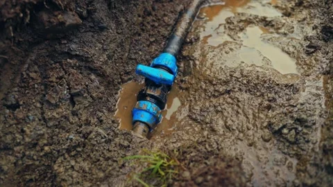 Underground Poly Pipe Compression Fitting And Ball Valve Leak In Muddy Trench Stock Footage 341553455