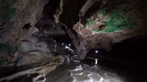 Underground stone grotto in cave and mountain river. Calcium cascades, waterf Stock Footage 221909317