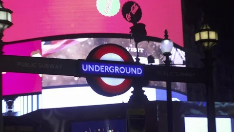 Underground subway sign lit up at night in london england Stock Footage 86837909