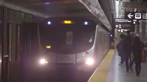 Underground subway train pulls into station, people board train Stock Footage 44266878