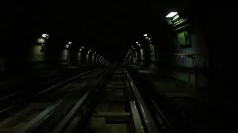 Underground train driving through a tunnel with green and white lights Stock Footage 37656711