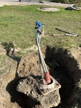 Underground utility cables emerging from a ground connection box Foto stock