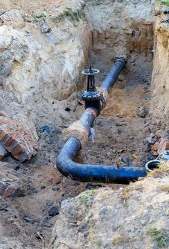 Underground utility pipeline with damaged thermal insulation Stock Photos