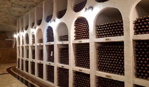 Underground wine cellar with collection of bottles, Cricova, Moldova Stock Photos