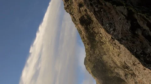 Underneath and behind waterfall at sunset, looking up Stock Footage 91254090