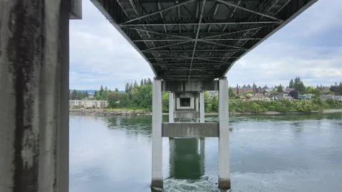 Underneath bridge flying through square pillars in Kitsap Stock Footage 154813193