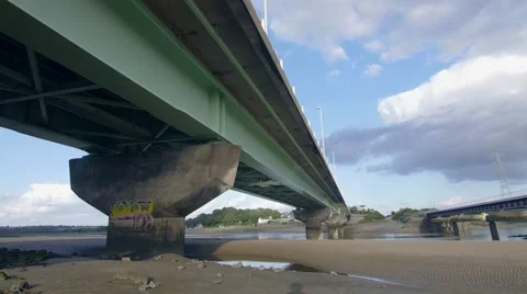 Underneath bridge over sand with graffiti Stock-Footage 66777757