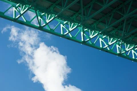 Underneath bridge view with cloud against blue sky. Stock Photos