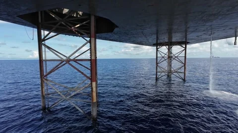 Underneath Jack Up Drilling Rig and Supply Vessel Stock Footage 278269459