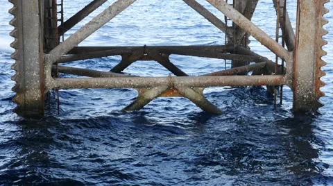 Underneath Jack Up Drilling Rig In The Ocean - Oil and Gas Industry Stock Footage 54653620