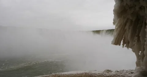 Underneath Niagara falls with icicles and snow panning to horseshoe falls Stock-Footage 229599879